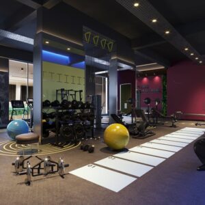 Modern gym interior with free weights, cardiovascular machines, and multi-station workout zones in a spacious, colorful setting.